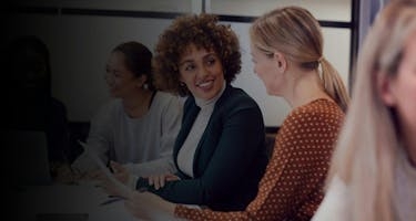 Women meeting at table discussing business