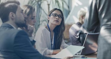 Business meeting of people discussing ASC 606 Revenue Recognition