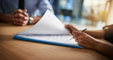 Professionals review lease documentation