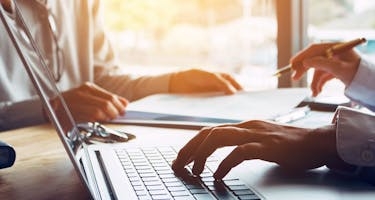 typing a soc compliance report on computer 