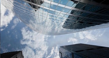 View from bottom of tall building with reflective windows